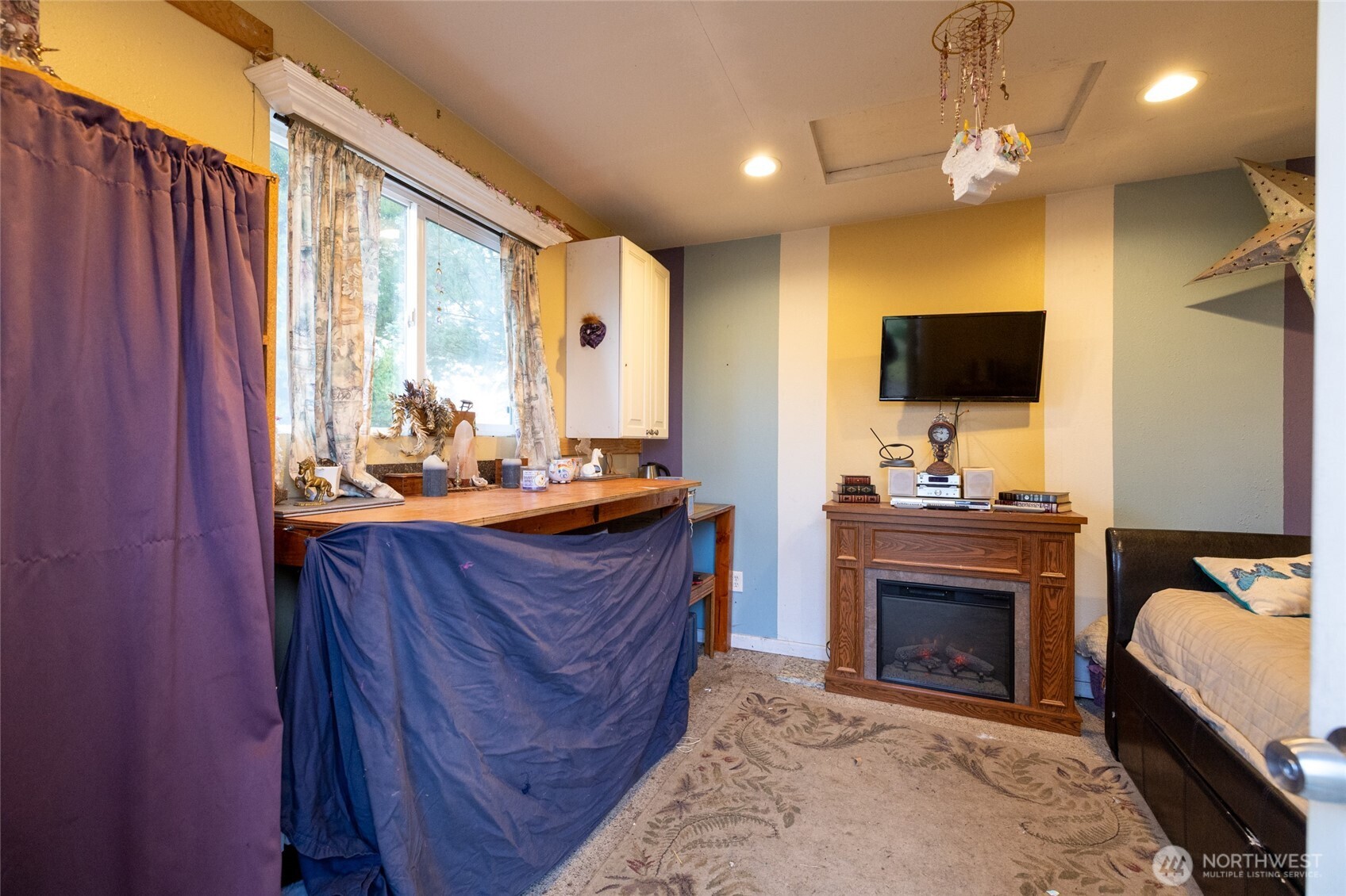 7332 183rd Avenue Southwest Rochester, WA 98579 - Photo 31 of 40 a living room with furniture a fireplace and a flat screen tv