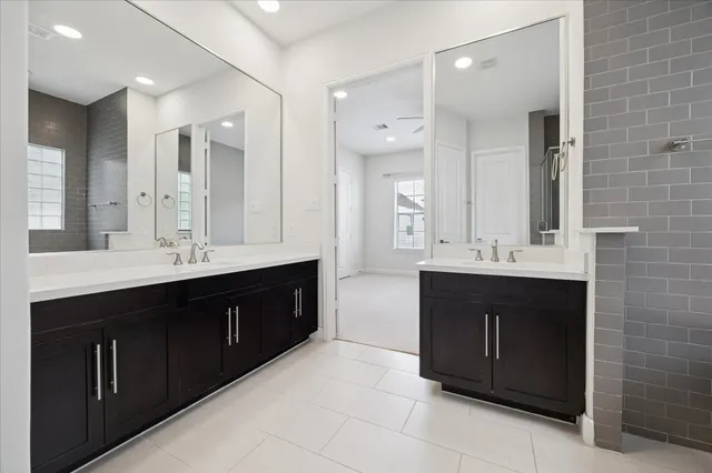 a bathroom with a double vanity sink mirror and double
