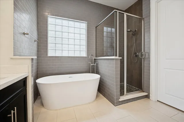 a bathroom with a bathtub and shower