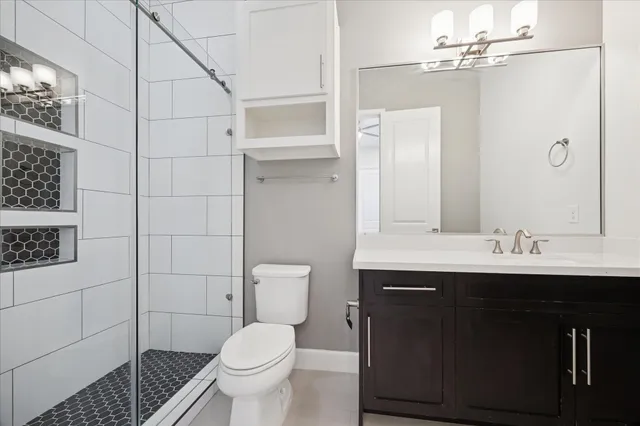 a bathroom with a sink toilet and shower