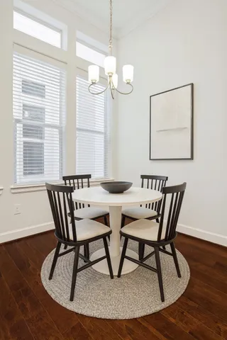 a view of a dining room with furniture window and wooden floor