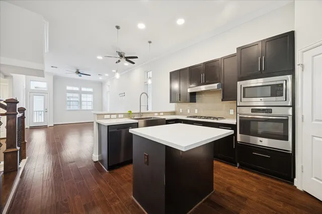 a kitchen with a sink appliances and cabinets