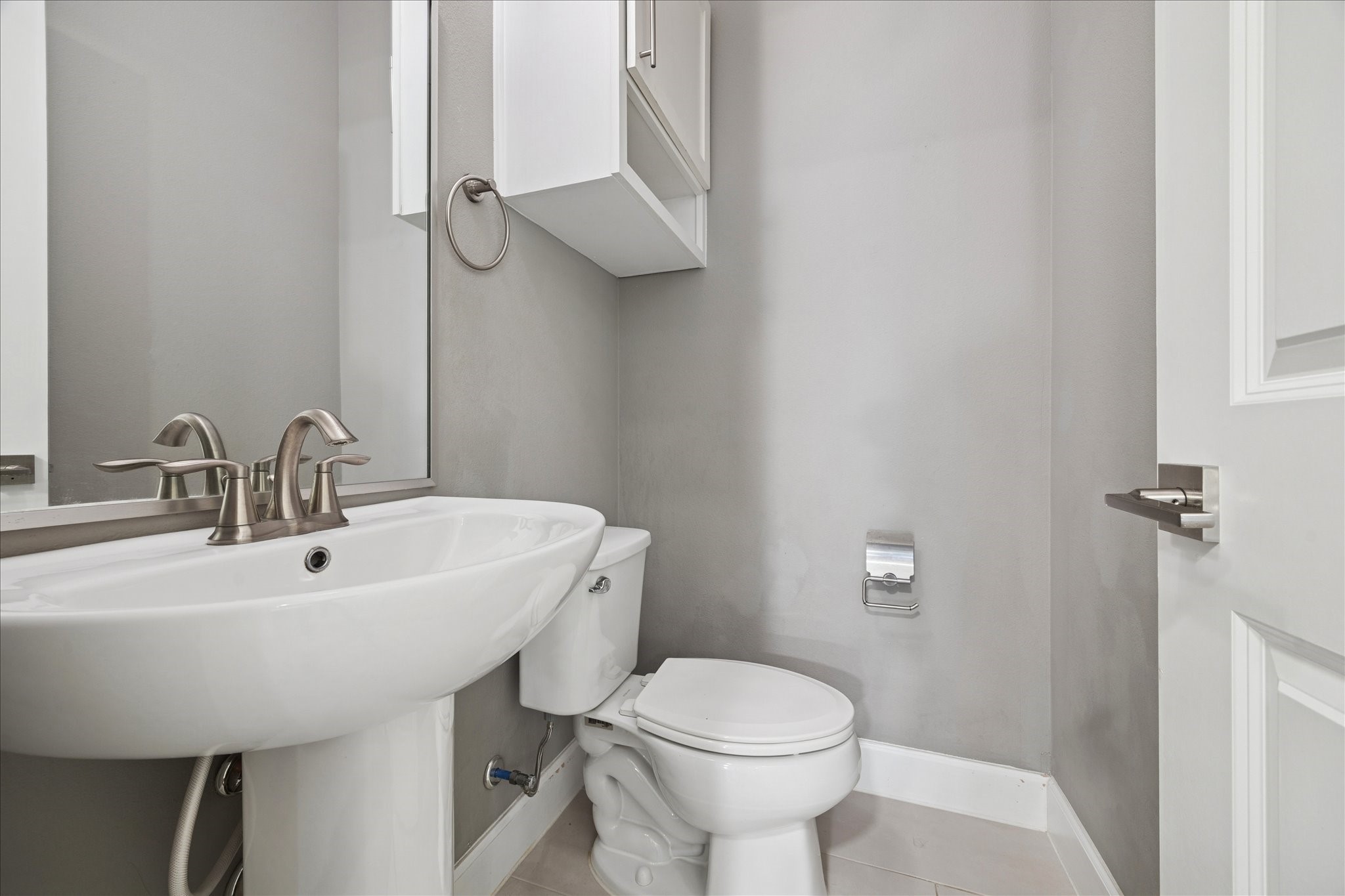 405 North Nagle Street, Unit B Houston, TX 77003 - Photo 9 of 24 a bathroom with a sink a toilet and a mirror