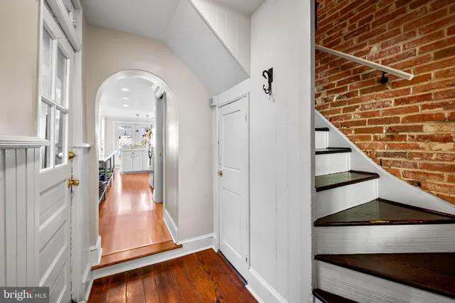 a view of an entryway with wooden floor and door