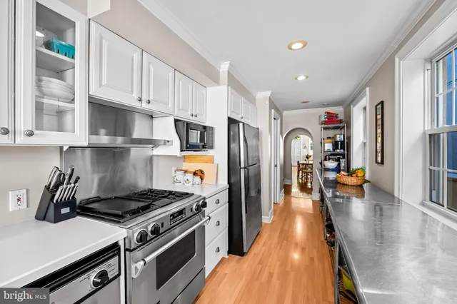 a kitchen with stainless steel appliances granite countertop a stove and a refrigerator
