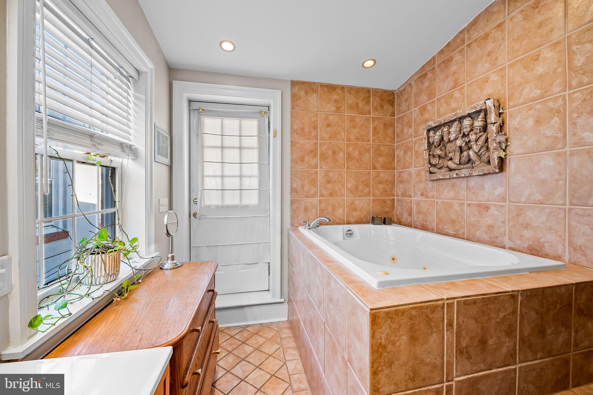 1908 Bank Street Baltimore, MD 21231 - Photo 25 of 37 a bathroom with a tub a sink and a shower