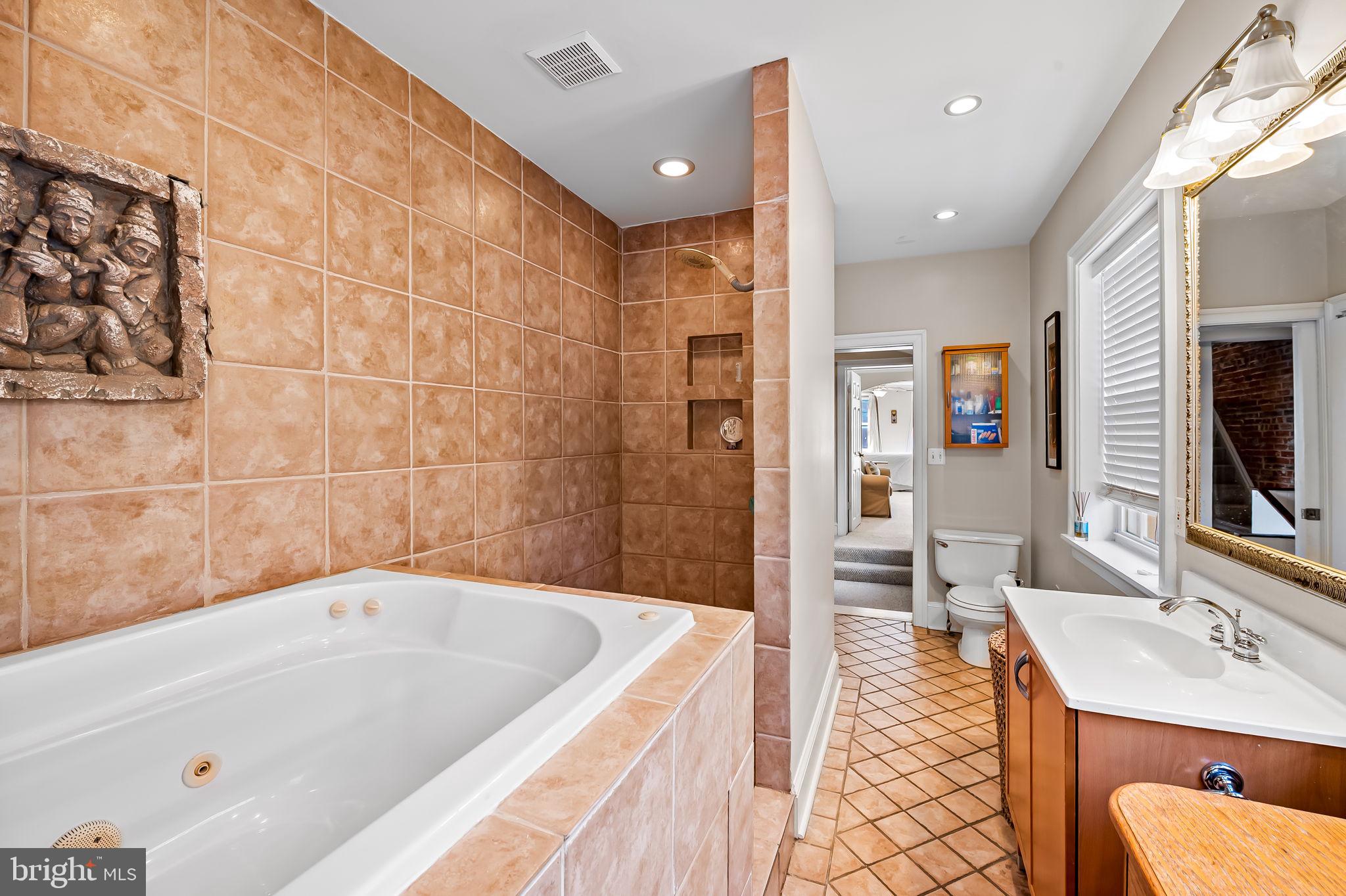 1908 Bank Street Baltimore, MD 21231 - Photo 28 of 37 a bathroom with a tub a sink and a large mirror