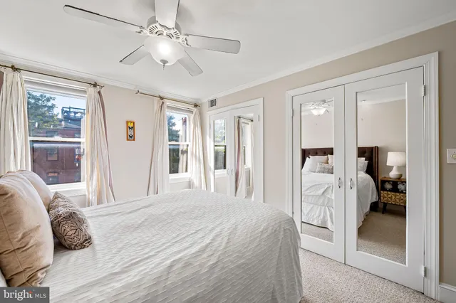 a spacious bedroom with a bed and a chandelier