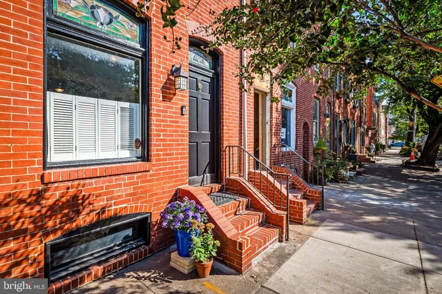 a backyard of a house with outdoor seating