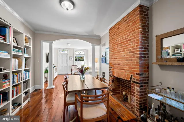a view of a dining room with furniture and a book shelf