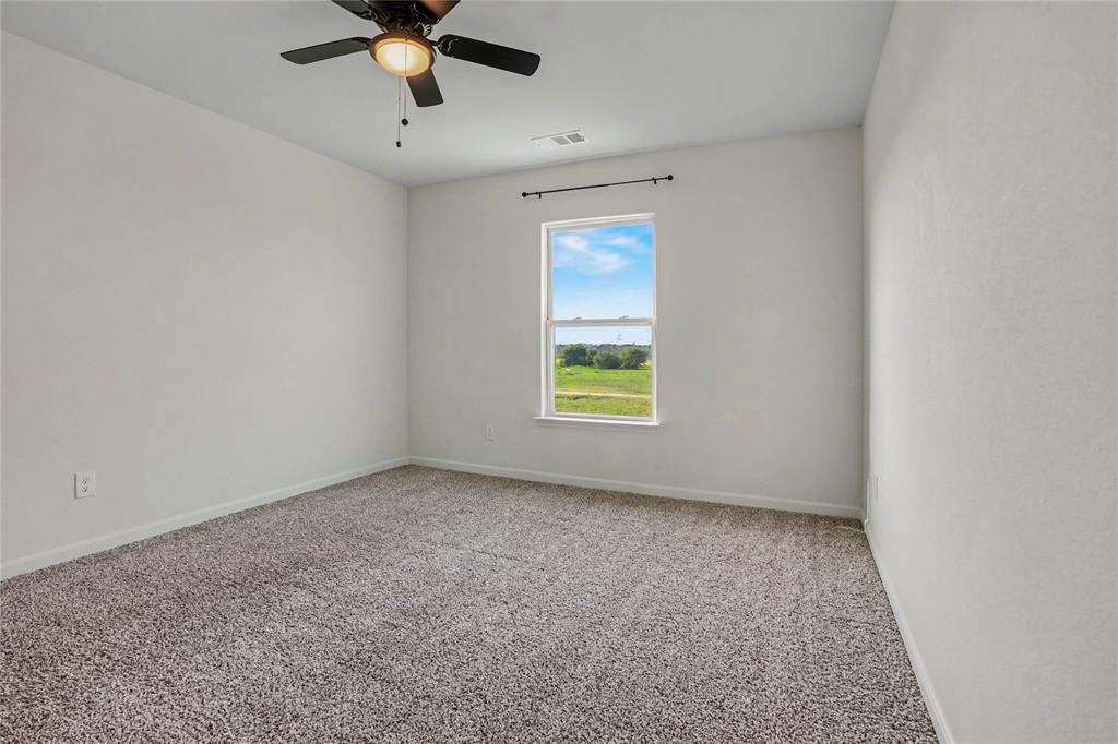 125 Sammy Venus, TX 76084 - Photo 28 of 39 Neutral-toned interior room featuring light gray wall paint, textured carpeting, and a window with a black curtain rod