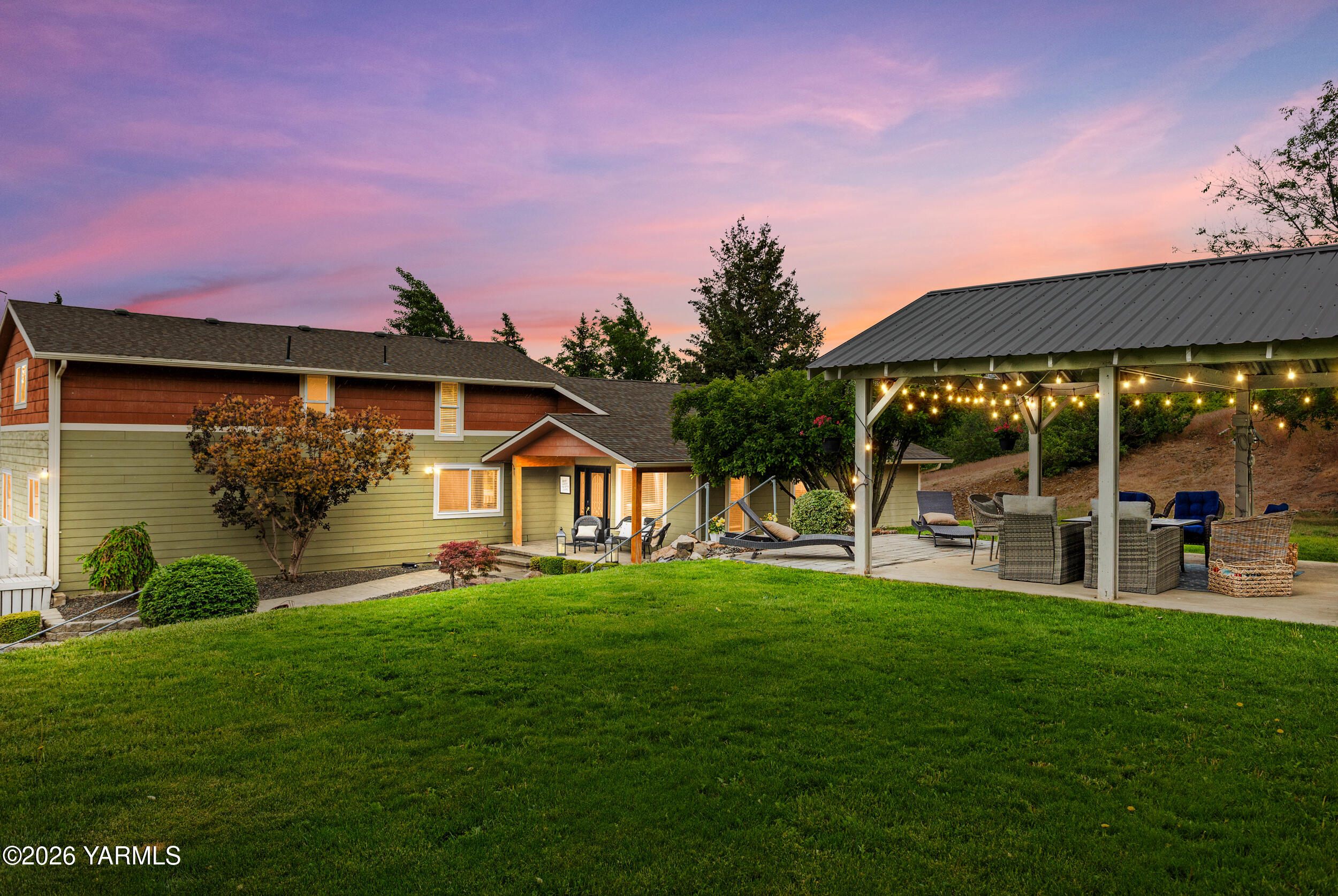 2121 Pleasant Hill Road Selah, WA 98942 - Photo 1 of 38 a front view of a house with a yard porch and sitting area