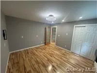 a view of an empty room with a mirror