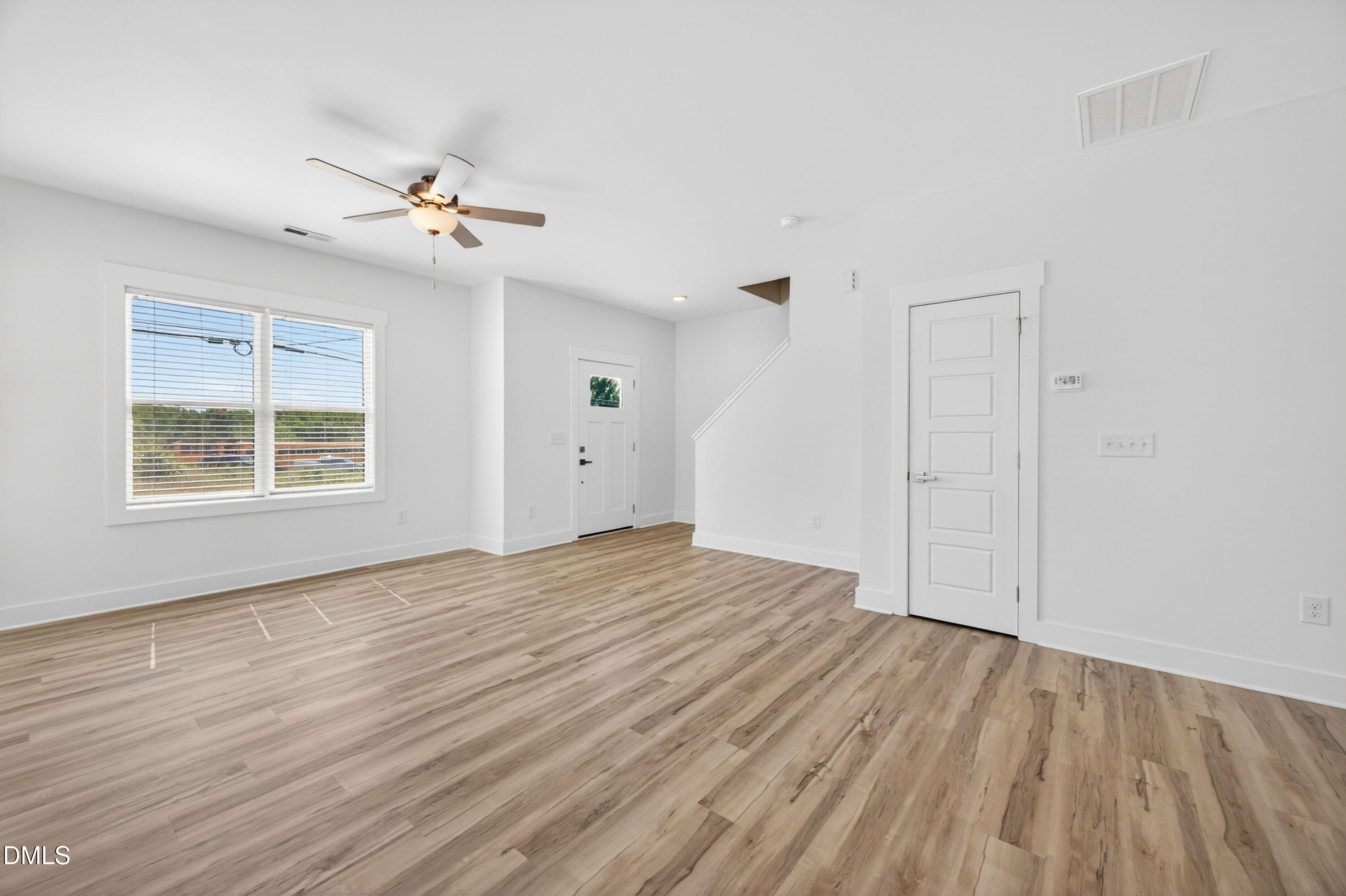 1256 Hurdle Mills Road Roxboro, NC 27573 - Photo 11 of 48 a view of empty room with wooden floor and fan