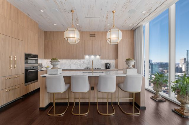a kitchen with center island table and chairs in it