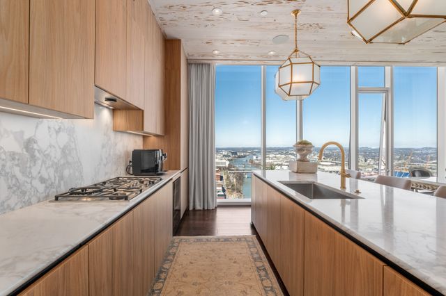 a kitchen with lots of counter top space and stainless steel appliances
