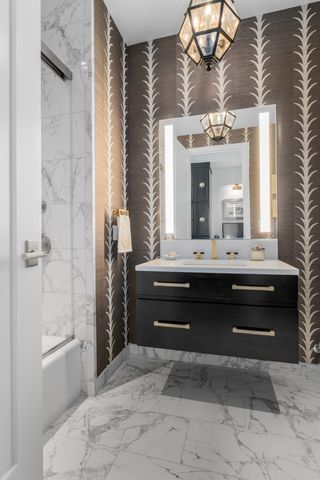 a bedroom with a bed a chair and next to a window