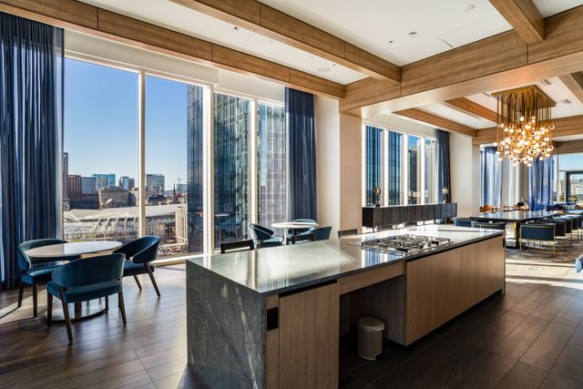 a living room with furniture and floor to ceiling window