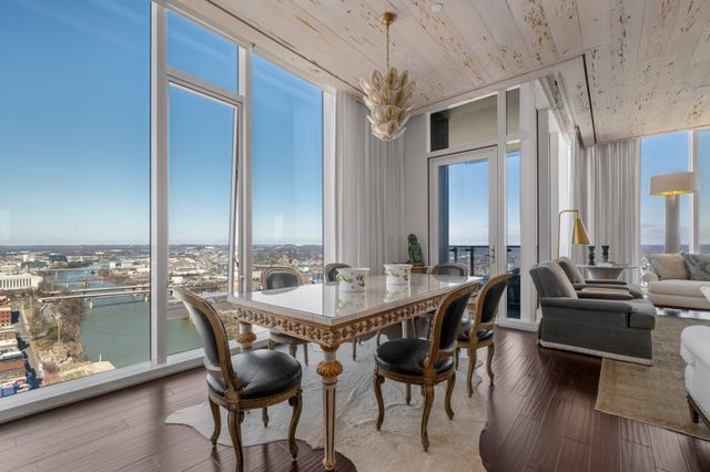 a living room with dining room and wooden floor