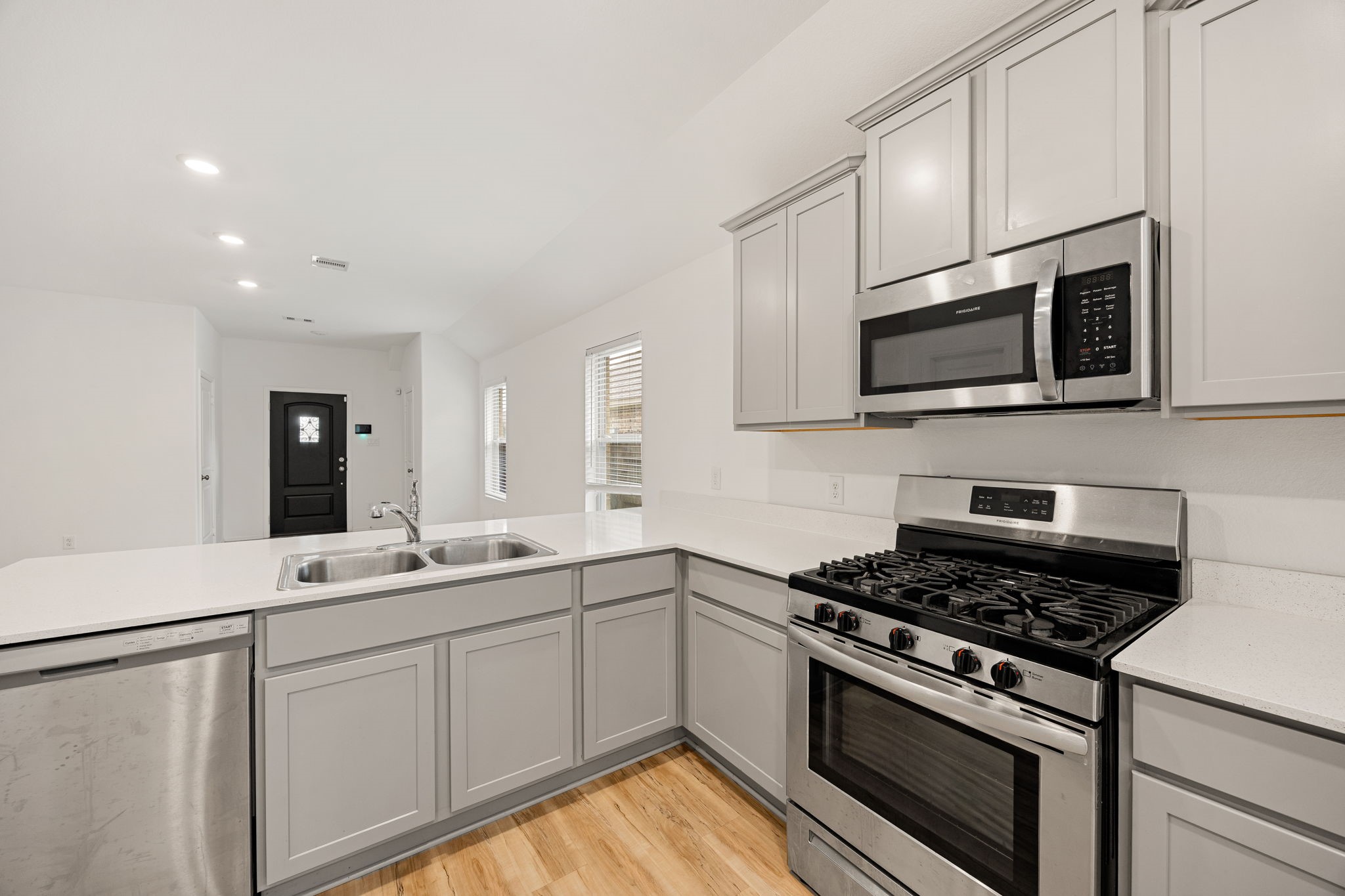 3014 Wedgewood Cove Way Porter, TX 77365 - Photo 11 of 24 a kitchen with stainless steel appliances a sink dishwasher a stove and microwave