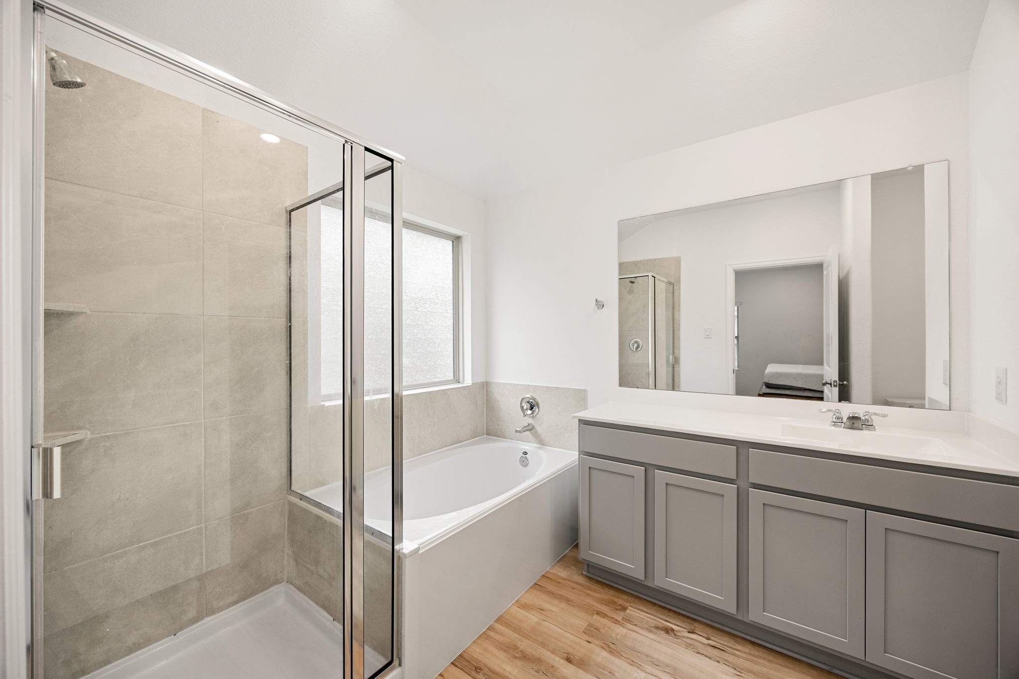 3014 Wedgewood Cove Way Porter, TX 77365 - Photo 13 of 24 a bathroom with a tub sink shower and mirror