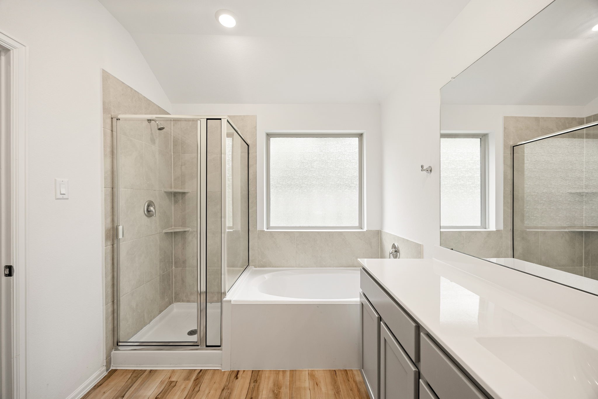 3014 Wedgewood Cove Way Porter, TX 77365 - Photo 14 of 24 a bathroom with a granite countertop sink a bathtub and shower
