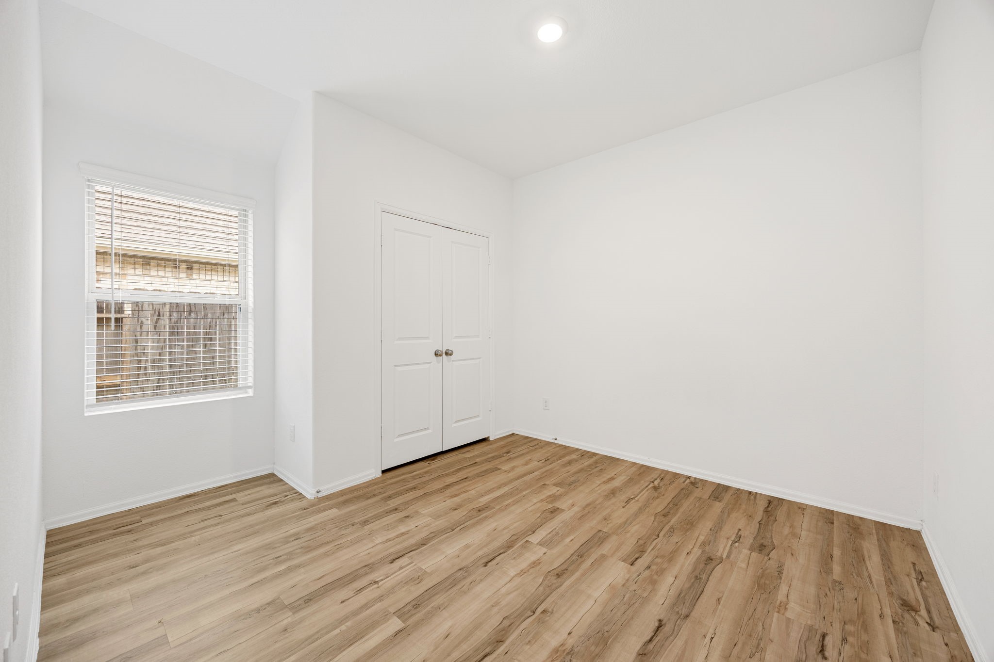 3014 Wedgewood Cove Way Porter, TX 77365 - Photo 16 of 24 an empty room with wooden floor and windows