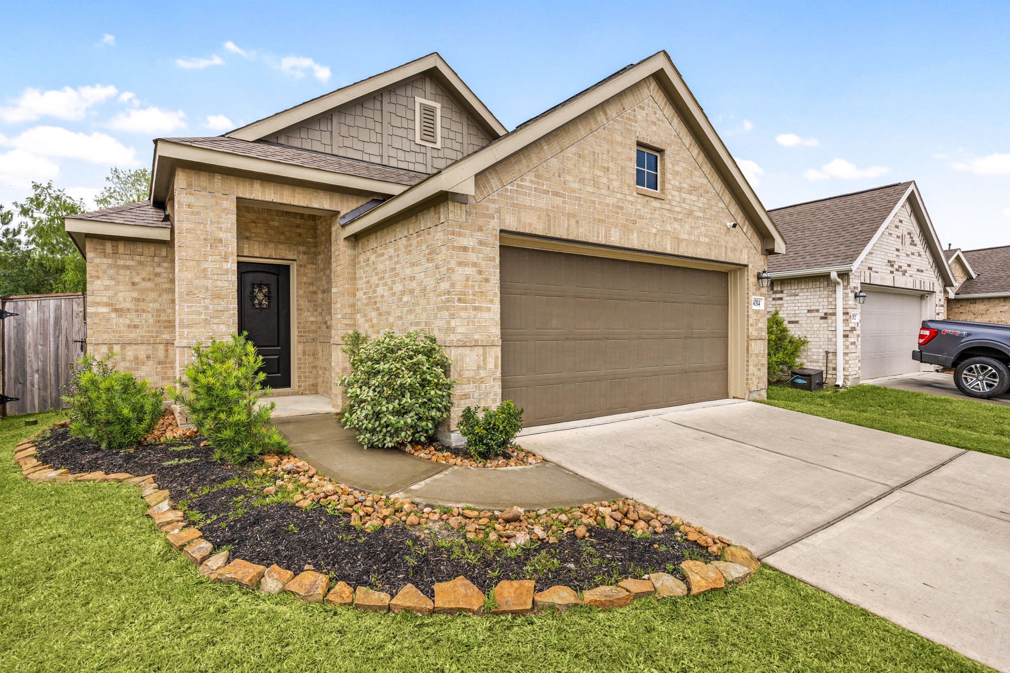 3014 Wedgewood Cove Way Porter, TX 77365 - Photo 3 of 24 a front view of a house with a yard and garage