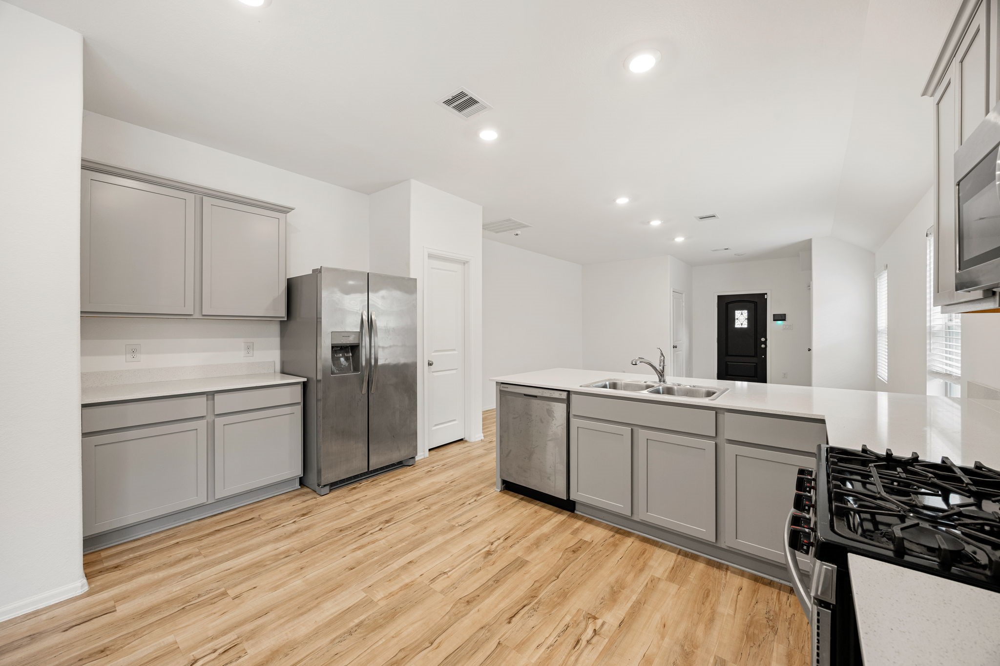 3014 Wedgewood Cove Way Porter, TX 77365 - Photo 9 of 24 a kitchen with a sink stainless steel appliances and cabinets