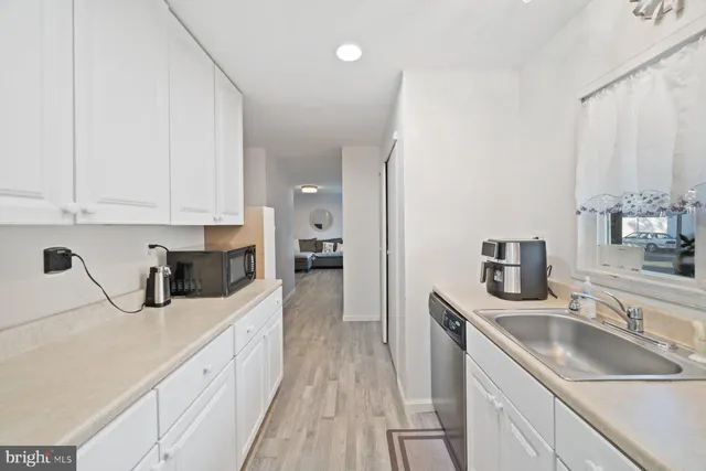 a kitchen with sink a stove and cabinets