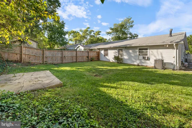 a view of a house with a yard and porch