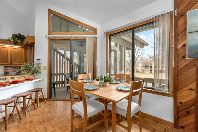 a dining room with furniture and large windows