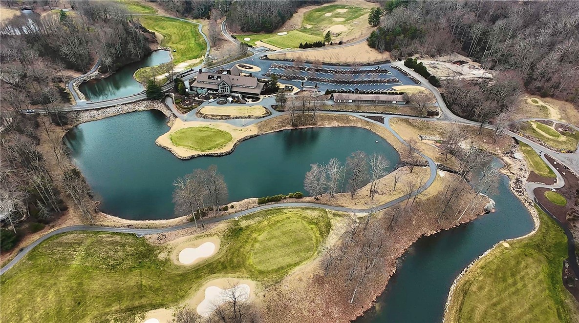 Lot 18 Raven Road Landrum, SC 29356 - Photo 5 of 7 An aerial view showcases a vibrant golf course with serene ponds and lush landscapes.