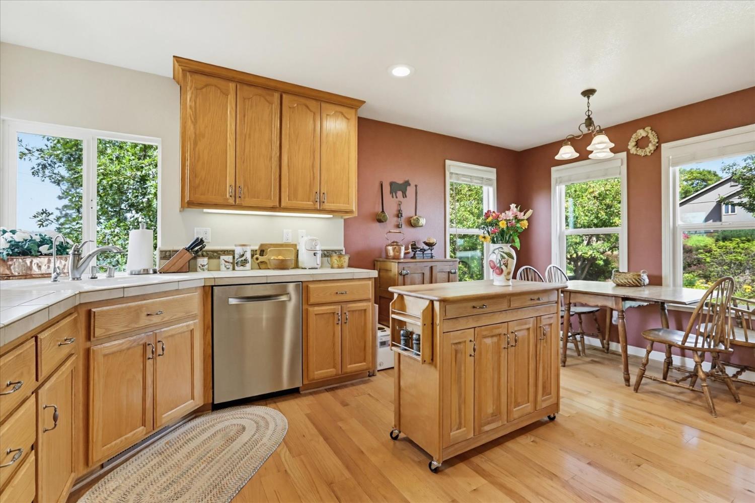 970 Morgan Ranch Drive Grass Valley, CA 95945 - Photo 13 of 76 a kitchen with sink cabinets and wooden floor