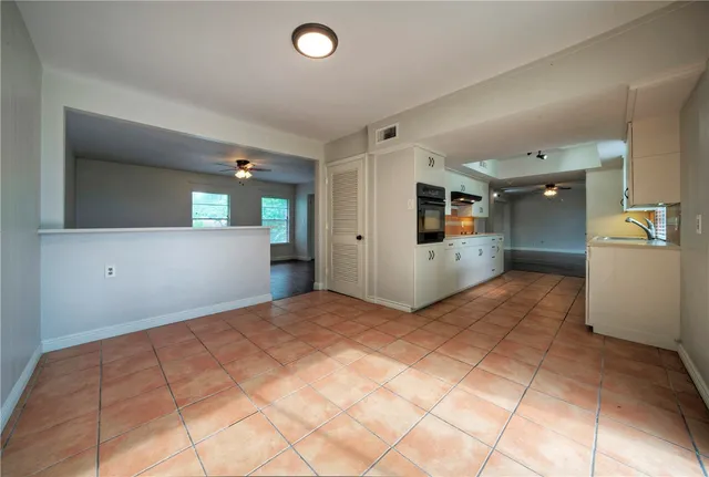 a view of a kitchen with a sink and cabinets