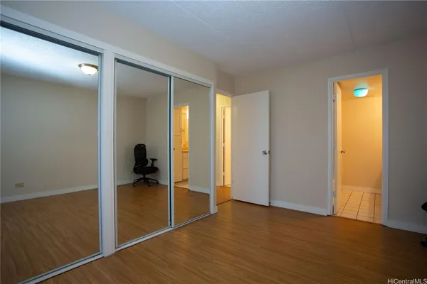 a view of a room with wooden floor