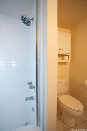a bathroom with a toilet and a shower