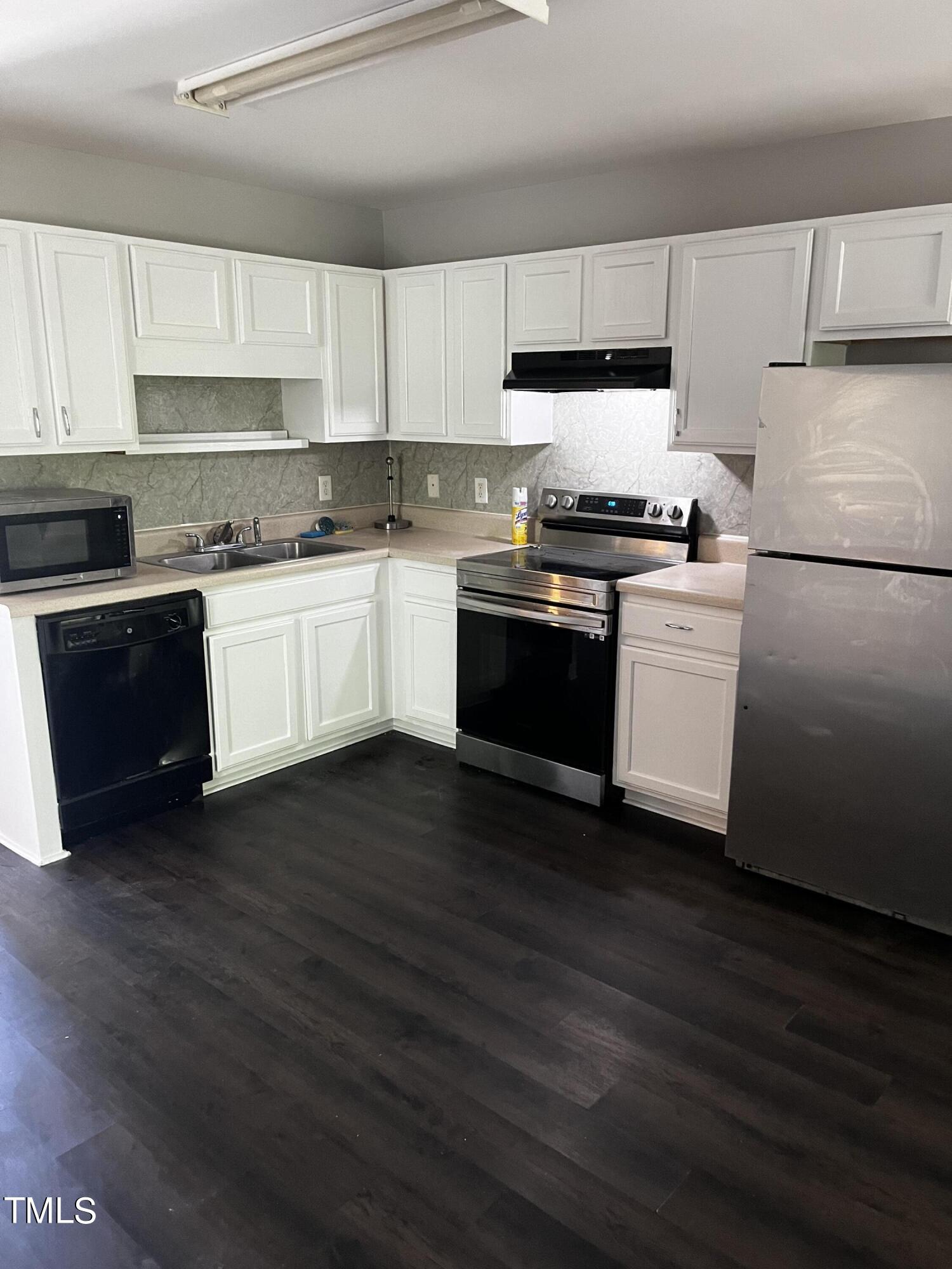 623 Rawls Drive Raleigh, NC 27610 - Photo 19 of 21 a kitchen with granite countertop wooden cabinets and a stove