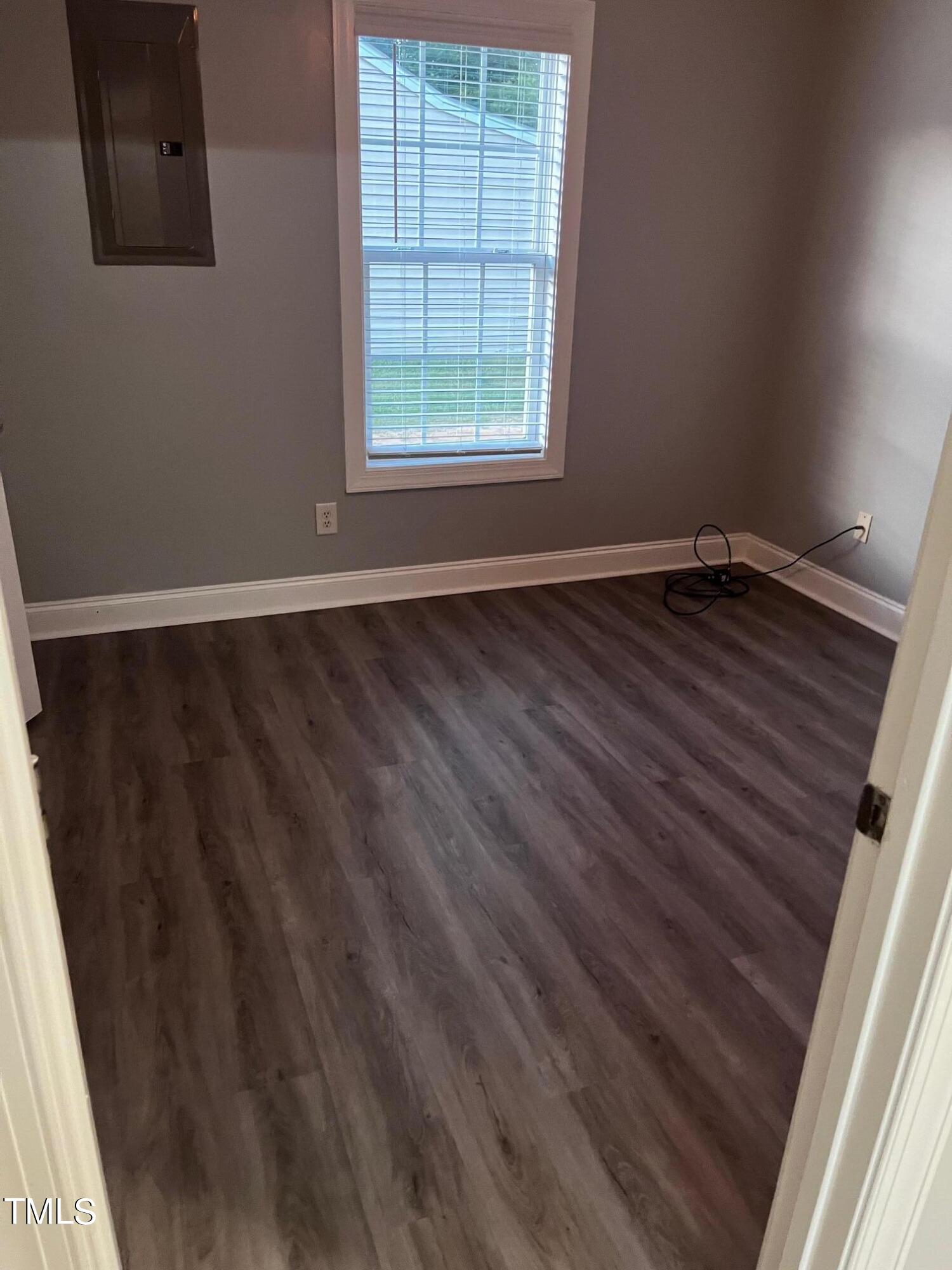 623 Rawls Drive Raleigh, NC 27610 - Photo 6 of 21 an empty room with wooden floor and windows