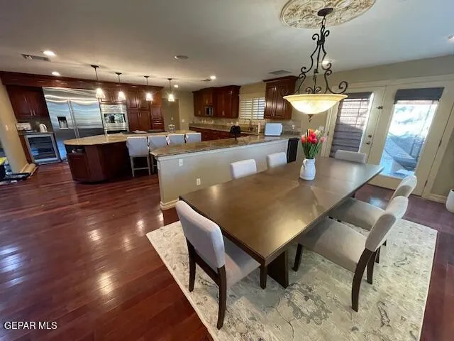 a living room with dining room and kitchen view
