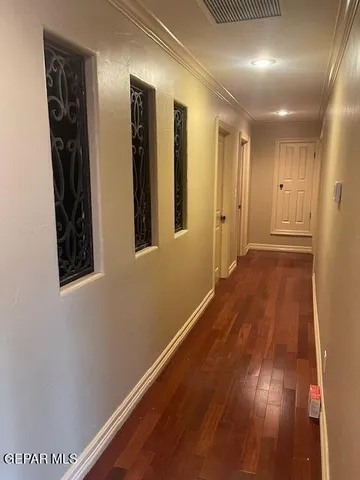 a view of hallway with wooden floor