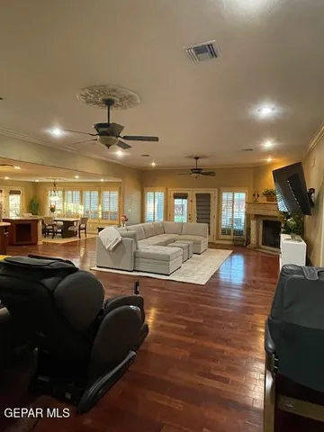 a living room with lots of furniture and kitchen view