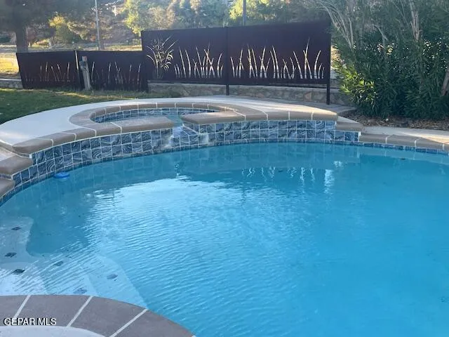 a view of a back yard with a wooden fence