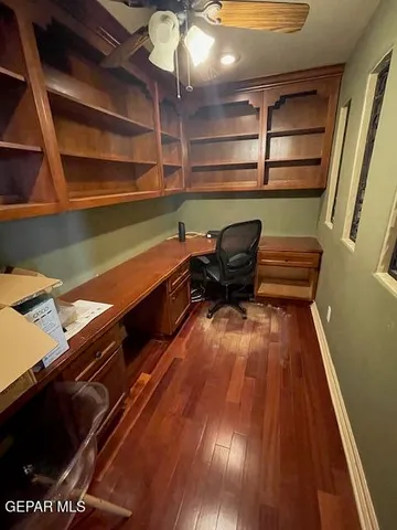 a sitting area with wooden floor