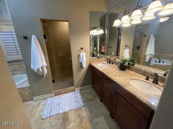 a bathroom with a double vanity sink and a mirror
