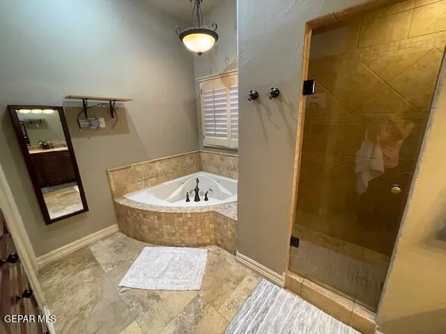 a bathroom with a bathtub and shower