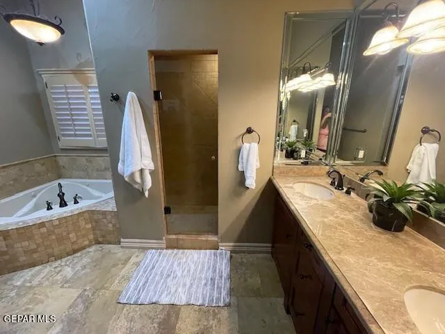 a bathroom with a tub sink and mirror