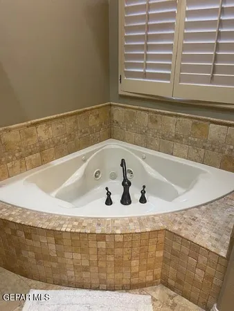 a bath tub sitting in a bathroom next to a window