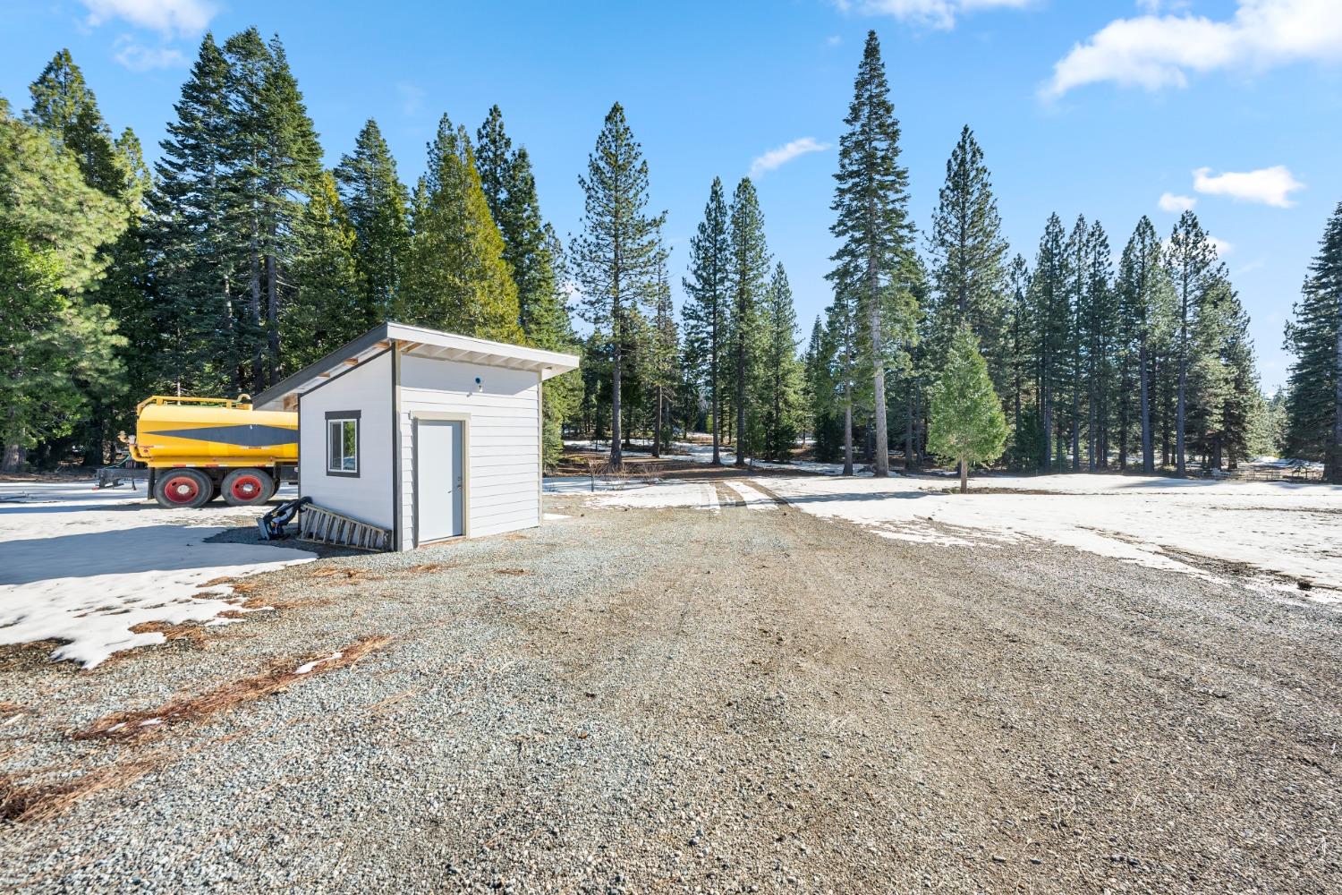 38787 Kearsarge Mill Road Alta, CA 95701 - Photo 11 of 16 a view of a white house with a yard and covered with trees