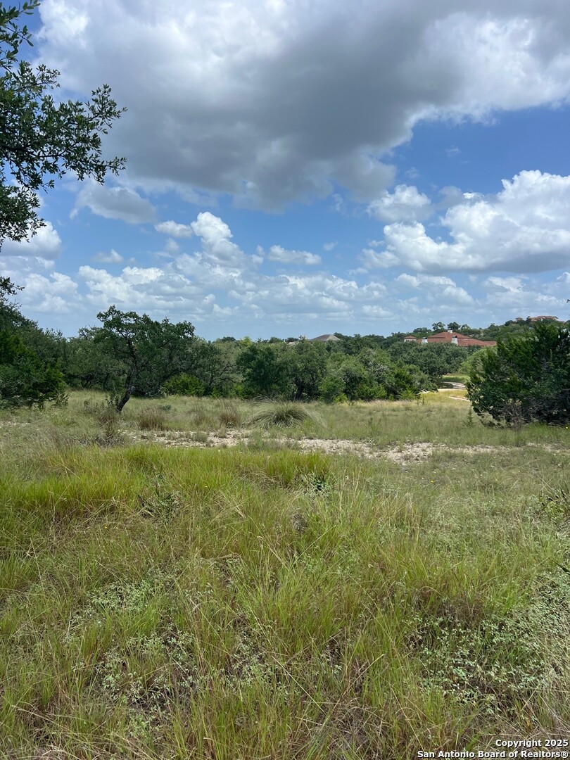 Lot 26 Winged Foot Boerne, TX 78006 - Photo 3 of 15 a view of a green field with wooden fence
